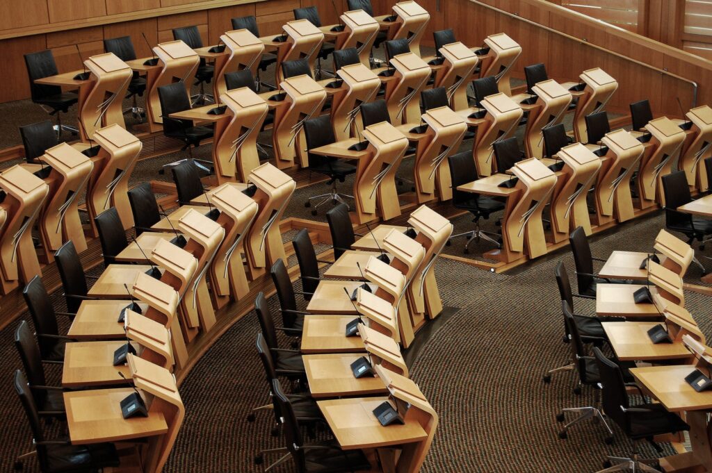 Rows of desks inside a parliament chamber