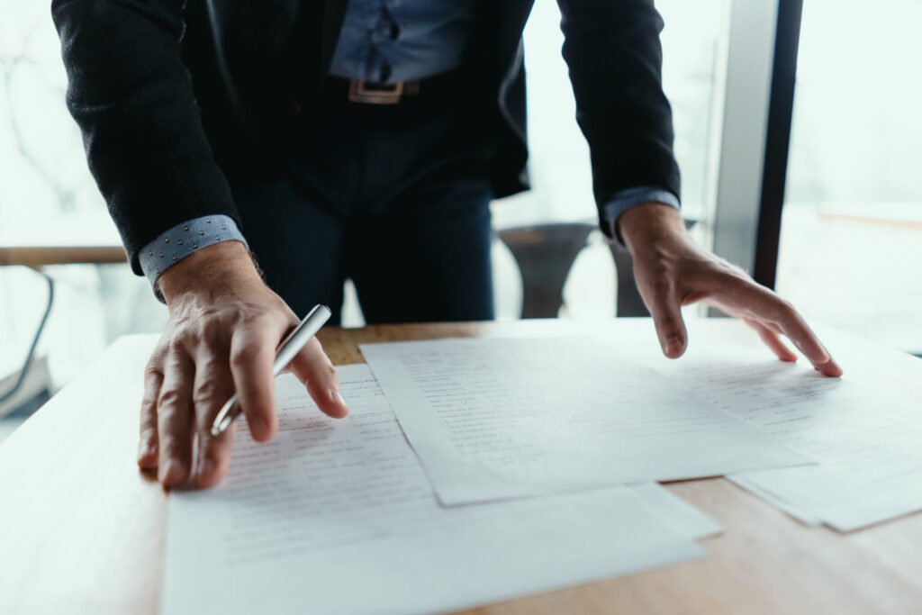 Businessman signing documents in a modern office