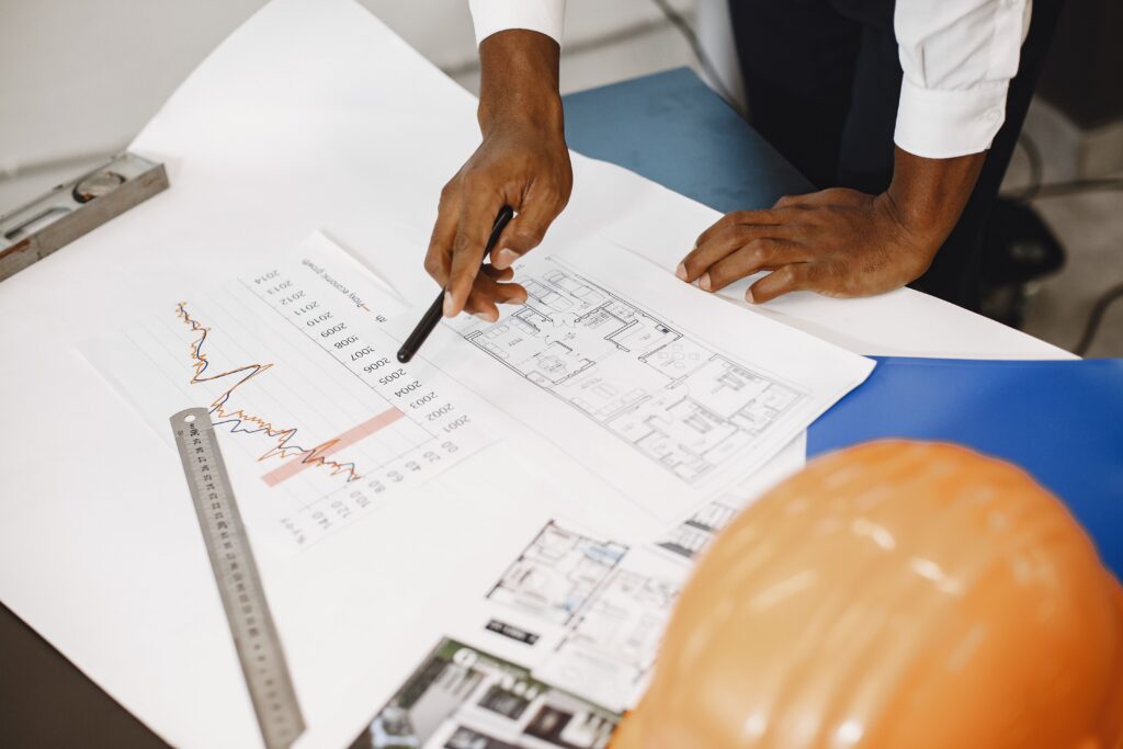 A contractor and a surety agent review project plans and financial statements during a bond application.