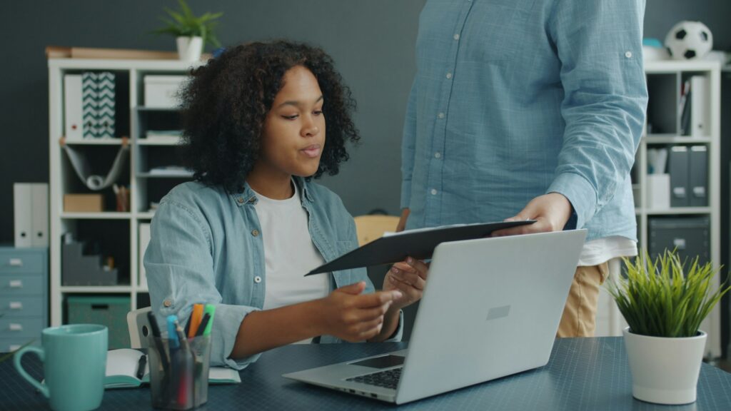 Business owner reviewing solicitation documents at a laptop while preparing a GSA Schedule offer