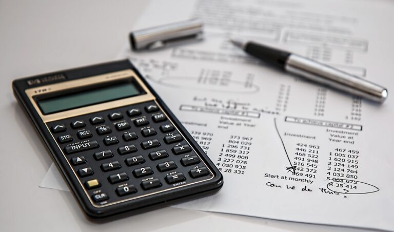Calculator and pen on a printed ledger, the everyday tools behind DCAA compliance for a small contractor