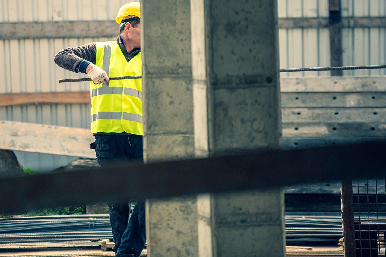 Construction worker in a high-visibility vest on a federal construction site covered by the Davis-Bacon Act
