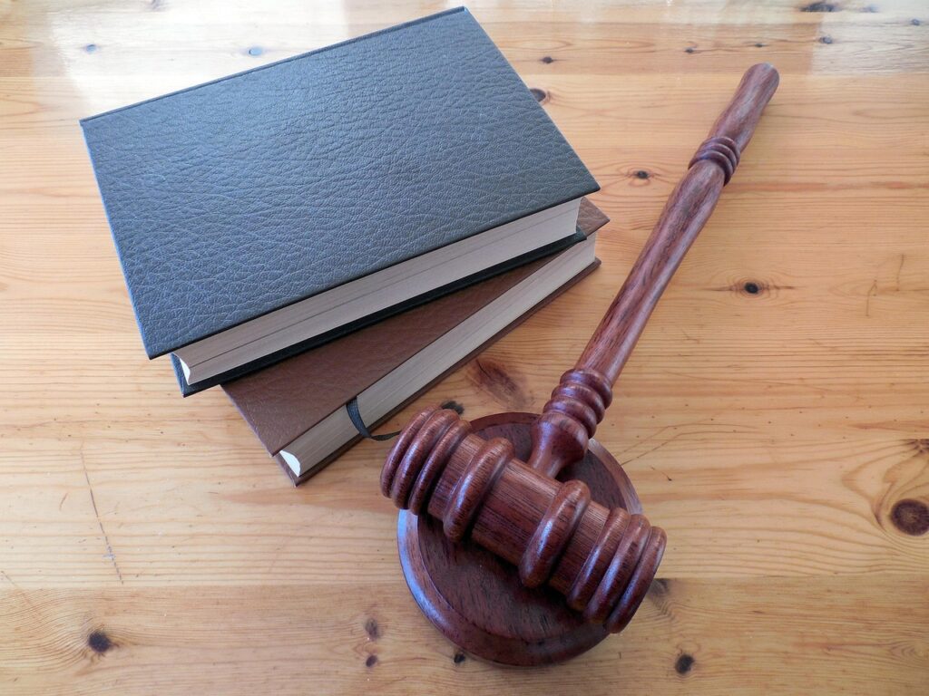 Gavel resting on law books, representing Davis-Bacon Act enforcement through Department of Labor proceedings and debarment