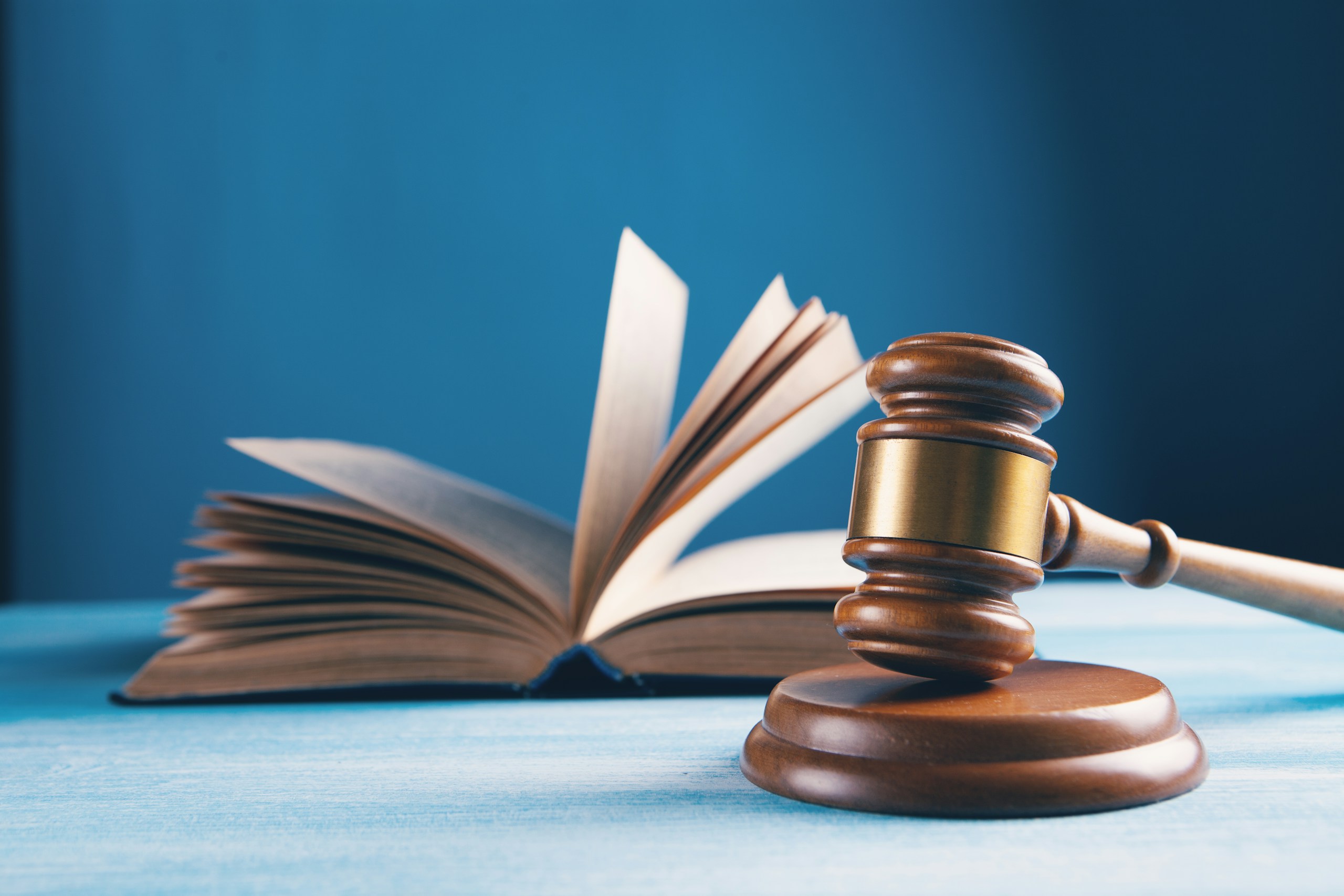 Gavel resting on an open law book, representing debarment and withheld payments for labor standards violations