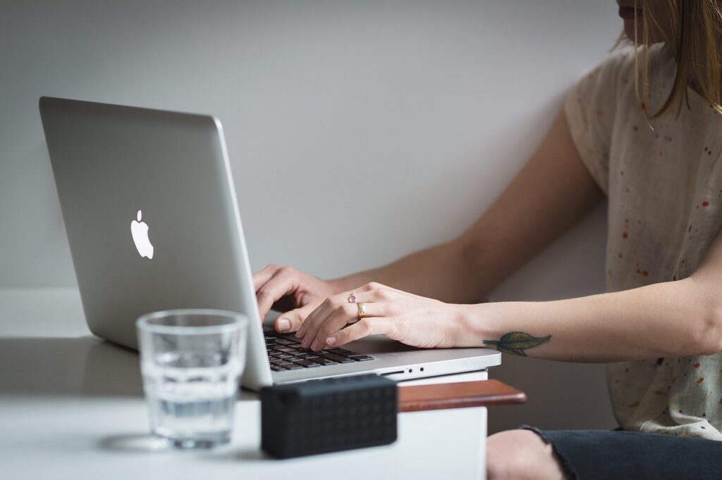 Small business owner searching federal solicitations on a laptop to find bids that need a teaming partner