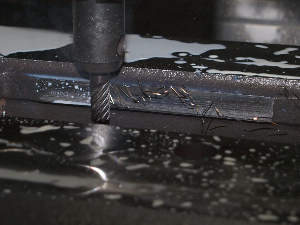 CNC milling machine cutting a metal part for a DLA parts contract