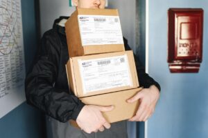 Courier carrying parcels on a delivery route for government courier contracts