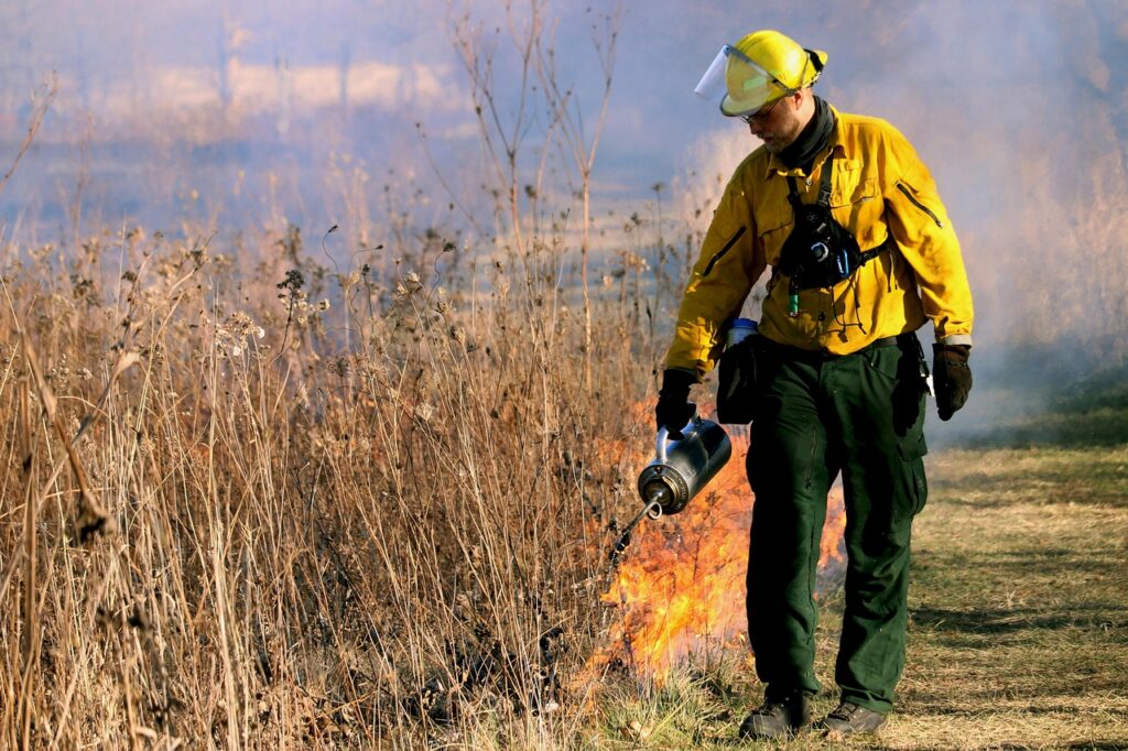 Wildland firefighter on a fire line, where Forest Service fire camp catering feeds crews