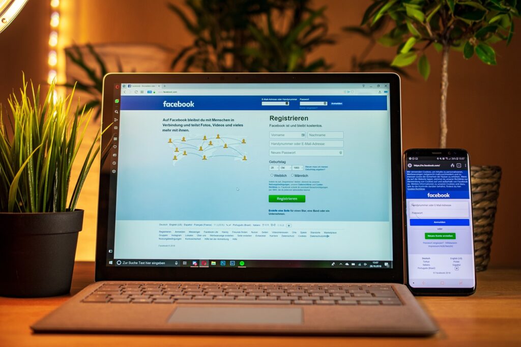 Laptop and phone on a desk, ready for online contractor registration