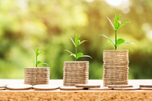 Growing coin stacks representing working capital from government contract factoring or FAR financing