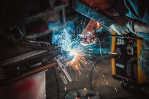 Welder fabricating steel in a job shop that bids on government welding contracts